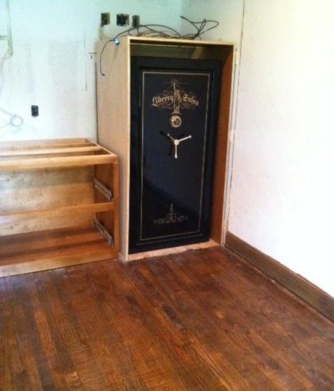 a liberty gun safe placed in a custom cabinet in a home