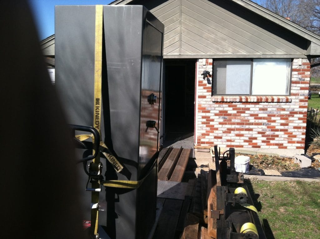 Fort Knox gun safe ready to be moved off the safe moving trailer down the ramps and into the side door of a home 2
