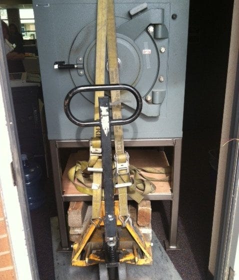 Diebold lug door safe on a pedestal being moved on a pallet jack