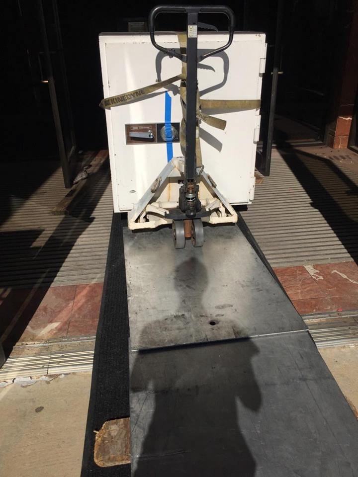 Moving a tl15 Diebold Cashgard bank safe out of the front doors of a bank on a pallet jack