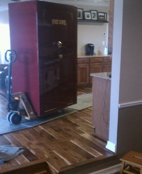 Here we are moving a large Fort Knox gun safe on a pallet jack through a house in Fort Worth over aluminum plates and runners to protect the floor