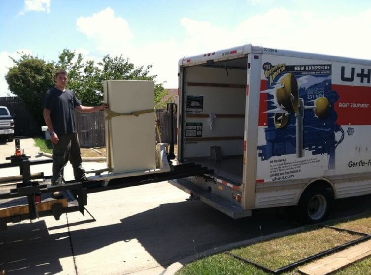 a safe mover rolling a file safe cabinet over ramps from a uhaul truck to our safe moving trailer 2