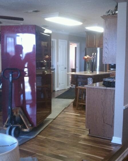 Large Fort Knox gun safe on pallet jack being moved through house over aluminum plates and runners 2