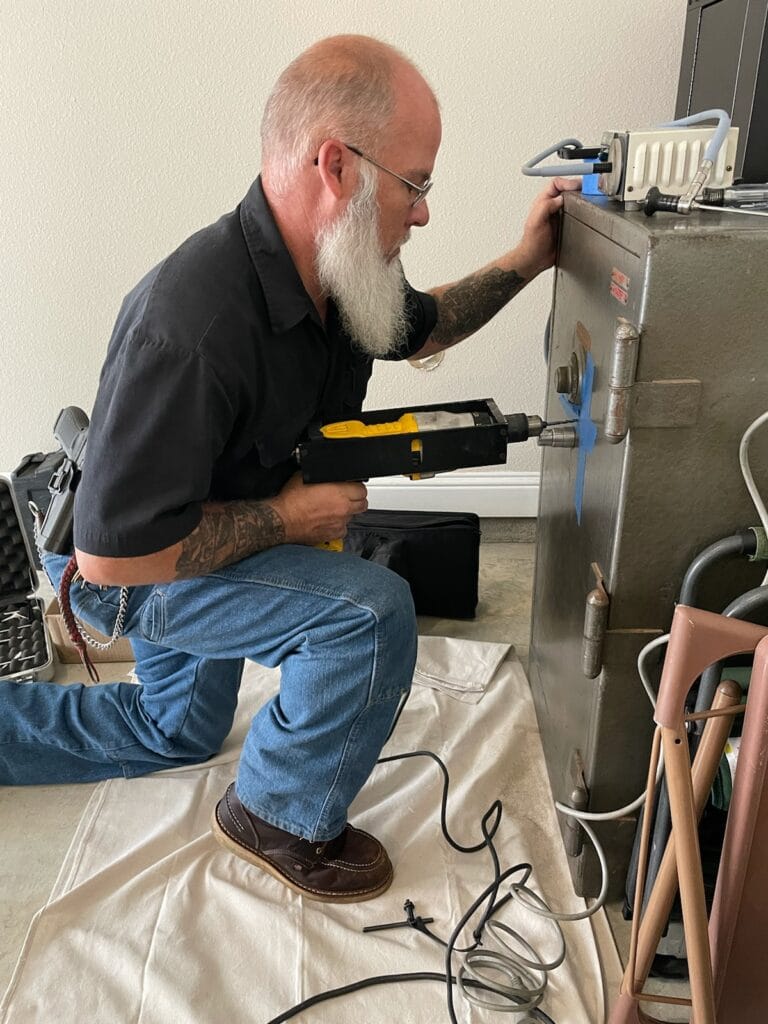Here our Master Safecracker is drilling open a safe that the customer lost his combination